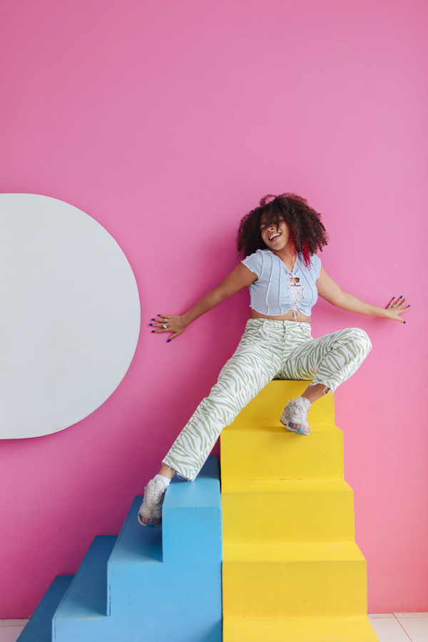 Jolly Woman Posing on Colorful Steps